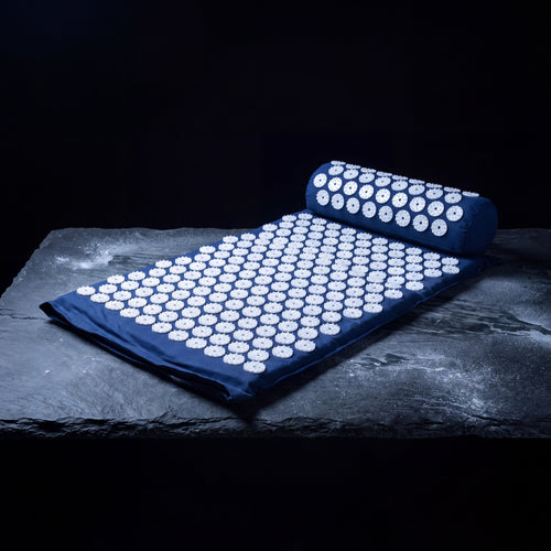 Nimbus Acupressure Mat and Pillow Set, navy, on a frosted slate shelf