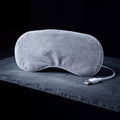 Nimbus Warm Eye Mask, grey USB heated eye mask, on a frosted slate shelf