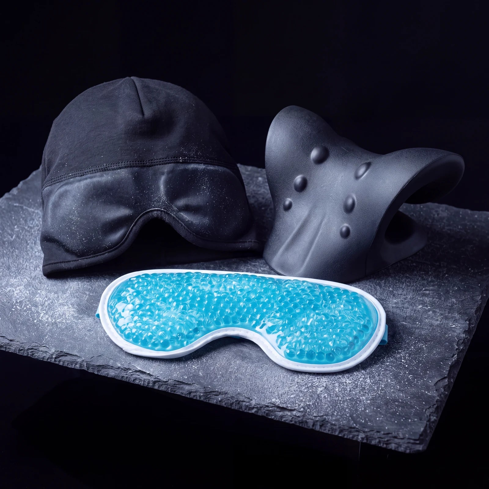 The Nimbus Cap, neck stretcher and cold gel eye mask together on slate